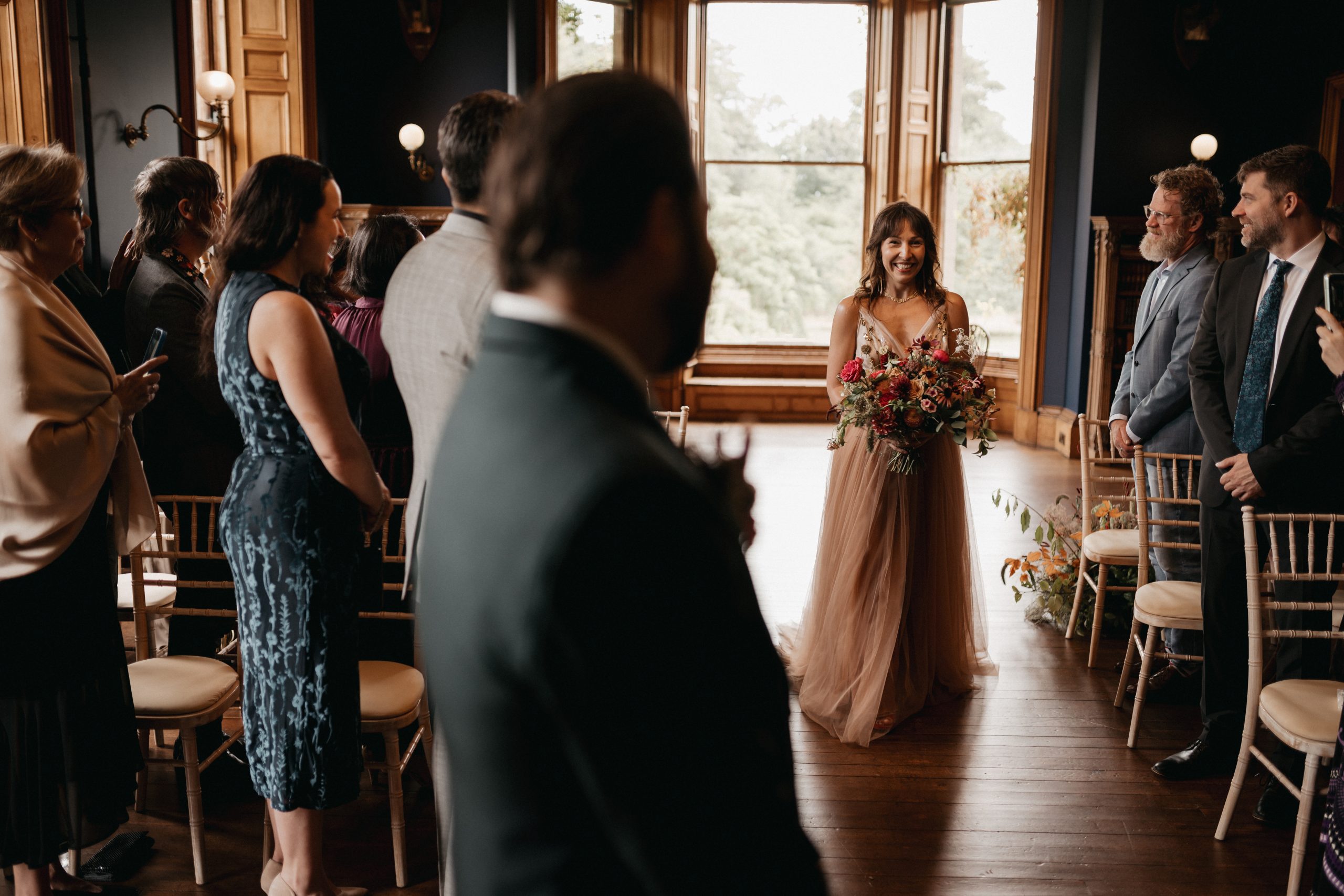 Bride walking down the aisle carrying wedding bouquet
