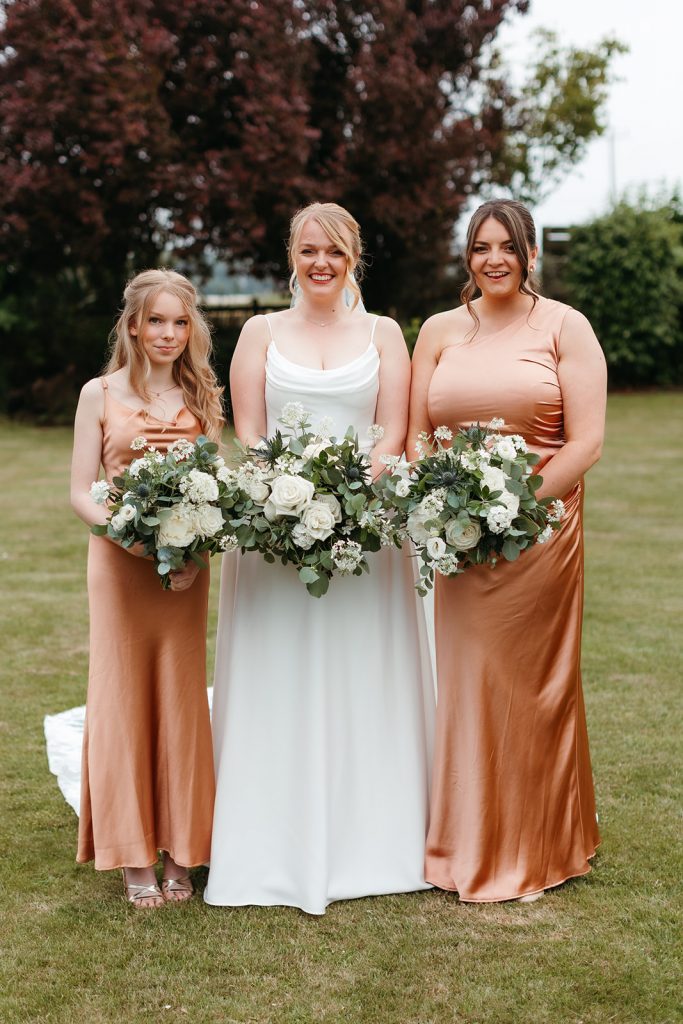 Weddings.bride + maids holding bouquets