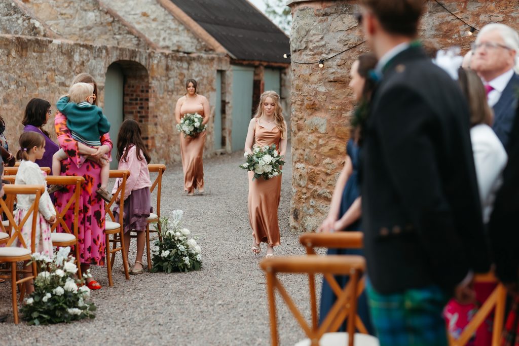bridesmaid walking down aisle