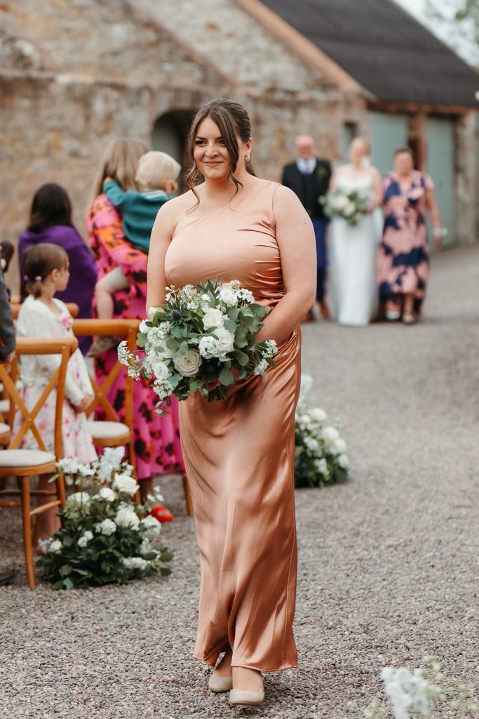 bridesmaid walking down aisle