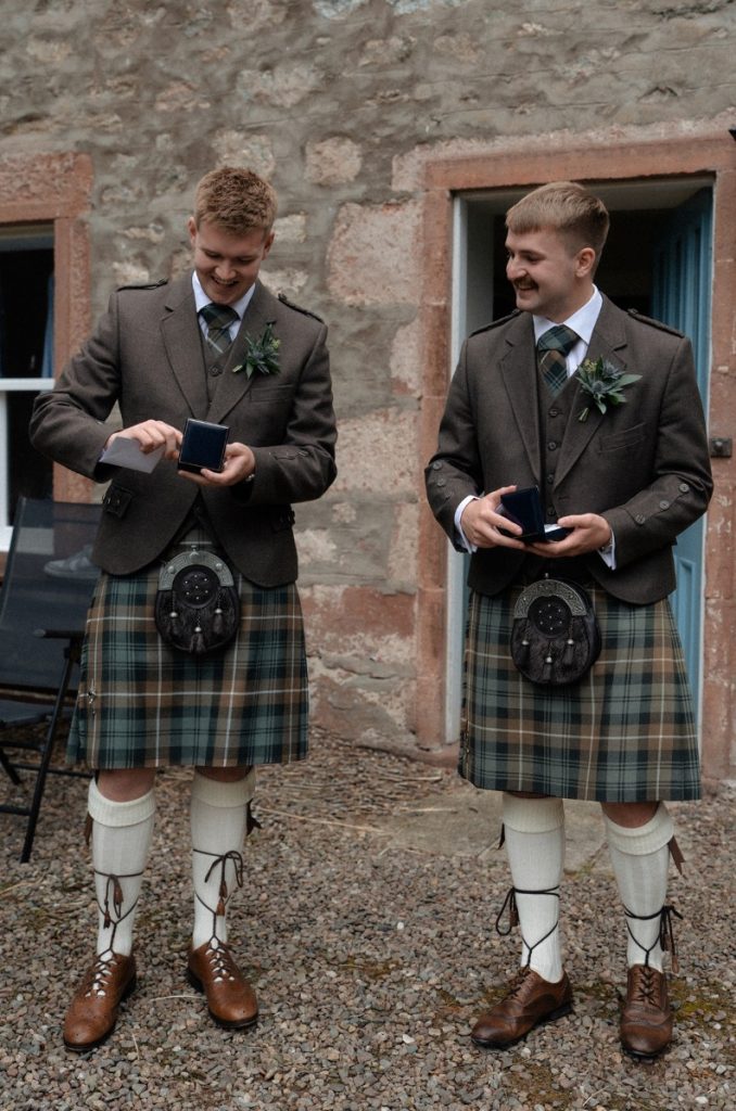 gents in kilts wearing buttonholes
