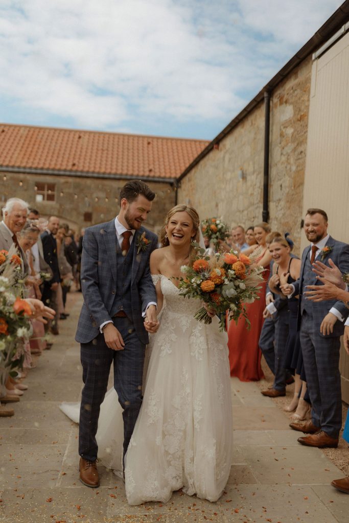 shades of orange wedding bouquet with dried flower accents