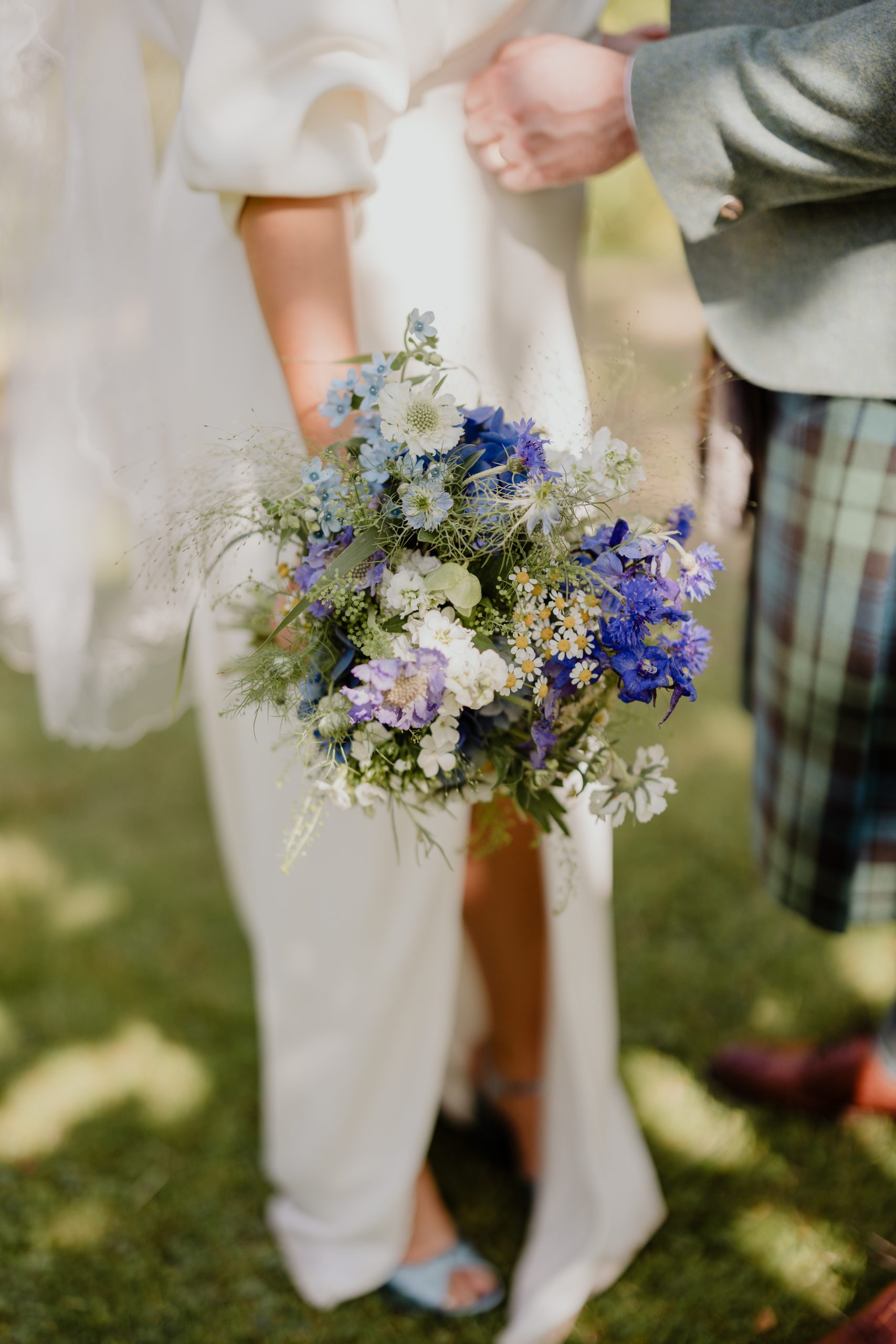 Perthshire Wedding at Rossie On the Earn. Bride holding blue + white bouquet by Fraoch Floral Design