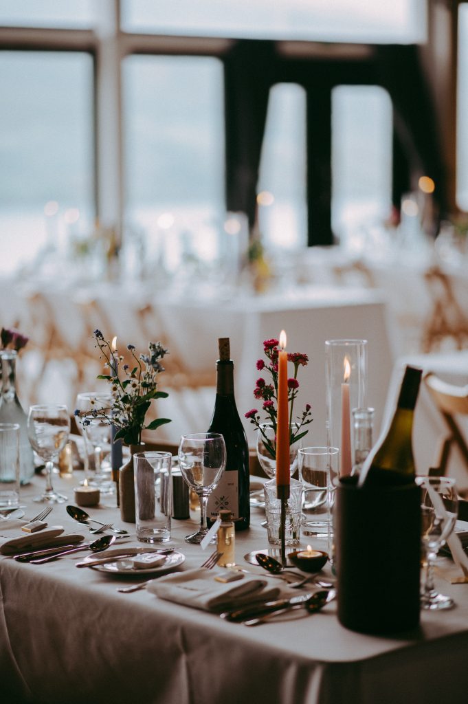 boreland-loch-tay-wedding-fraoch-floral-design 6 - fraoch floral design fraoch floral design elegant banquet table set for a formal event with candles, wine, and floral centerpieces.